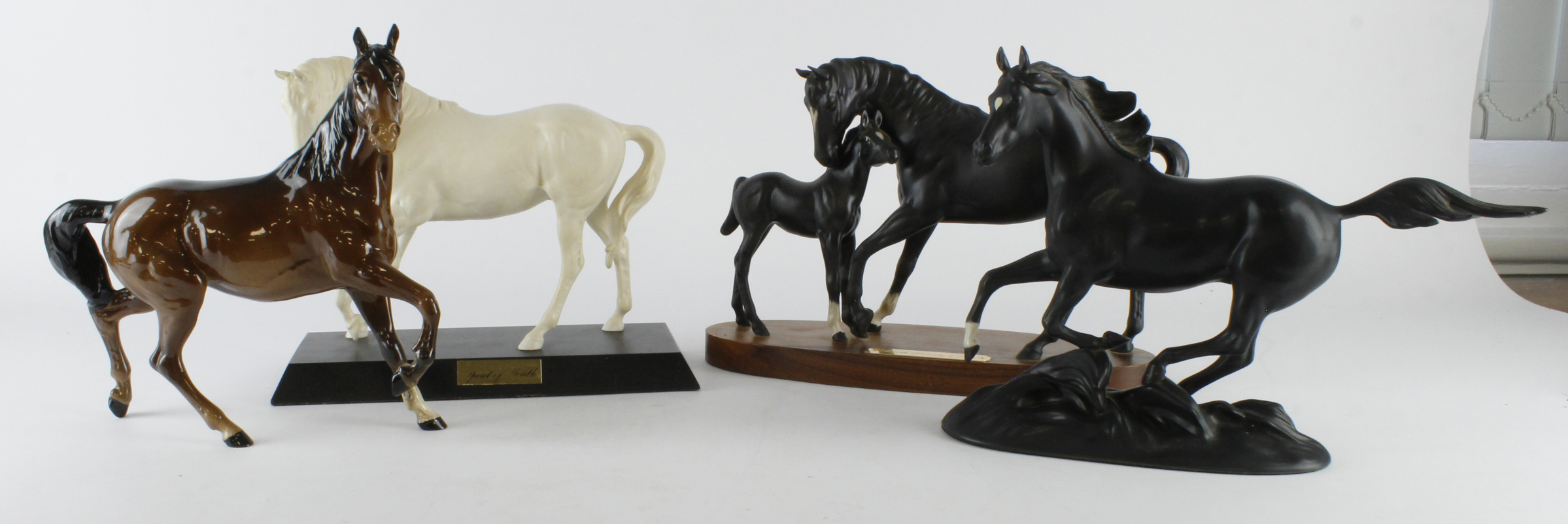 Four horse figures, makers include Royal Doulton & Franklin Mint, tallest 22cm approx.