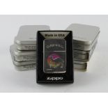 Zippo. A group of seven cased Zippo lighters, including Beatles, Rolling Stone, John Wayne, Titanic,