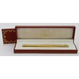 Cartier. Les Must de Cartier gold plated ballpoint pen, contained in original case