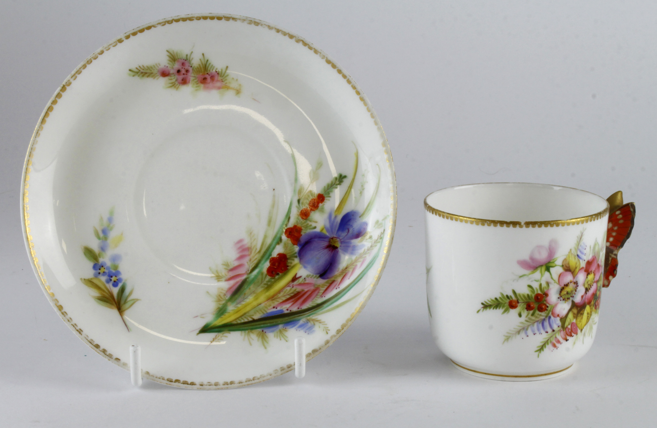 Royal Worcester cup and saucer, hand painted floral decoration with butterfly handle to cup,