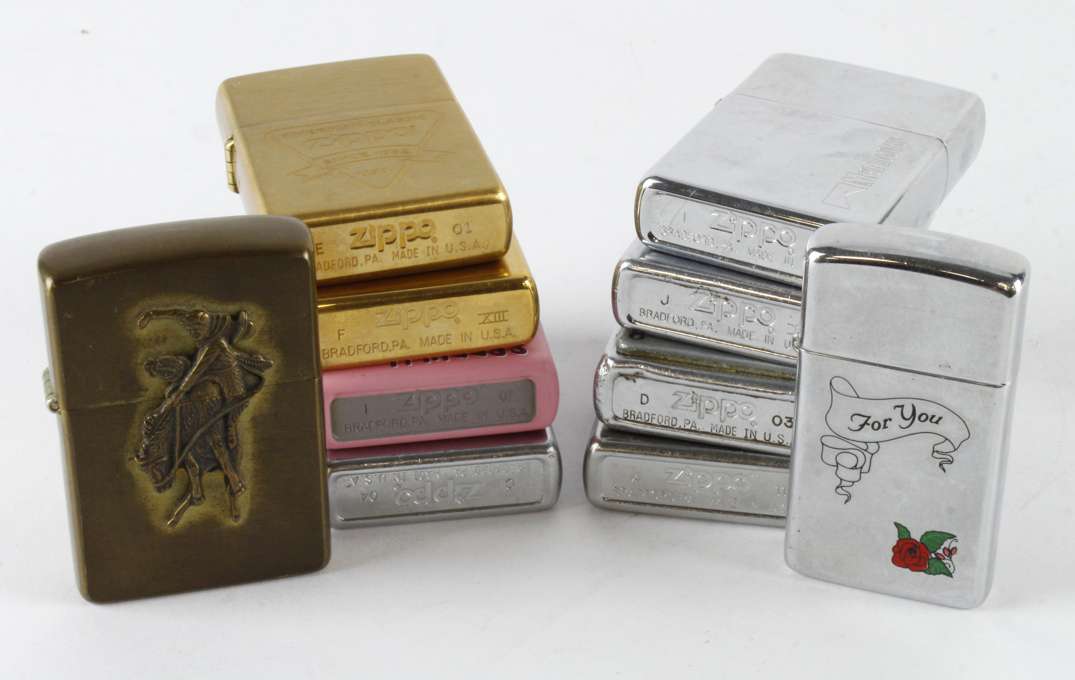 Zippo. A group of ten Zippo lighters, including Ford, Beatles, Marlboro, etc.