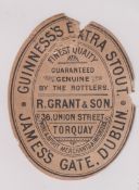 Beer label, Guinness's Extra Stout, a rare c1896 vertical oval bottled by R Grant & Son, Torquay,