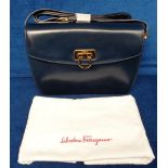 Salvatori Ferragamo, a navy leather shoulder bag with gold coloured clasp (unused, with protective