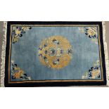 A late 20th century Chinese wool piled rug, the central medallion with dragons, a bat and lotus