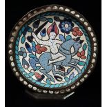An early 20th century Persian brass and enamel charger decorated with a warrior on horseback,
