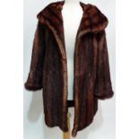 A ladies brown mink fur jacket with wide collar, brown silk lining and velvet lined pockets, size