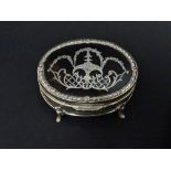 A silver and tortoiseshell picque oval trinket box on four cabriole feet, the lid with trellis and