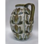 A large Denby Glyn Colledge stoneware jug decorated with stylised flower motifs, impressed and