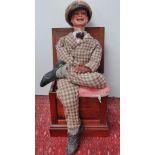 An early 20th century ventriloquist's dummy with papier mache head and glass eyes, with internal