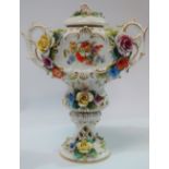 An early 20th century Sitzendorf twin handled vase and cover, with applied floral decoration,