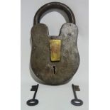 A massive iron and brass padlock with two keys, height 28.5cm.