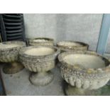 A set of five reconstituted stone classical style footed planters, height 48cm.