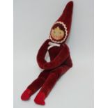 A early 20th century pixie doll in the manner of Norah Wellings, with plush maroon velvet body,
