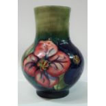 A William Moorcroft baluster shaped vase, tubeline decorated with pansies, impressed and painted