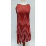 A French 1920s ladies flapper dress, the sheer red chiffon embellished with white and grey beads