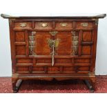 A 19th century Korean figured elm and softwood cabinet with brass butterfly hinges and lock plate,