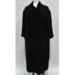 A ladies mid 20th century black woollen coat with astrakhan trim to the collar, label for Hardy