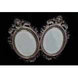 A good Italian silver Rococo style double oval photograph frame, with scroll and shell surmounts and