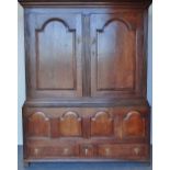 An 18th century oak housekeeper's cupboard, the upper section fitted arcaded panel doors with reeded