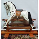 A Victorian style carved wood rocking horse in the manner of F.H. Ayres, the body with dappled