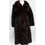 A ladies brown mink fur full length coat, brown silk lining, size 10/12, length 104cm.