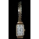An Art Deco yellow metal ladies cocktail watch by J.W. Benson of London, with silvered dial and