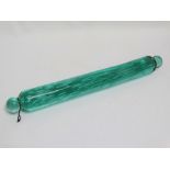A late 19th/early 20th century heavy green glass rolling pin, with numerous bubble inclusions,