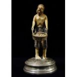 An unusual 19th century possibly Indo Portuguese ivory and white metal figure of a farmer holding