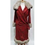 A 1920s ladies red patterned day coat with fur trim to the collar, sleeves and hem, sage green