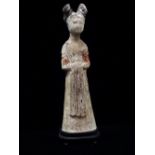 Tang Dynasty circa 618-907, a Chinese terracotta tomb figure of a female courtier with traces of