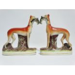 A pair of 19th century Staffordshire pottery figures of coursing greyhounds, height 28cm.
