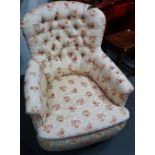 A late 19th century upholstered button back armchair with turned front legs and brass castors.