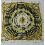 A Hermes Paris silk scarf, decorated with the zodiac signs in gold and black to a cream ground,