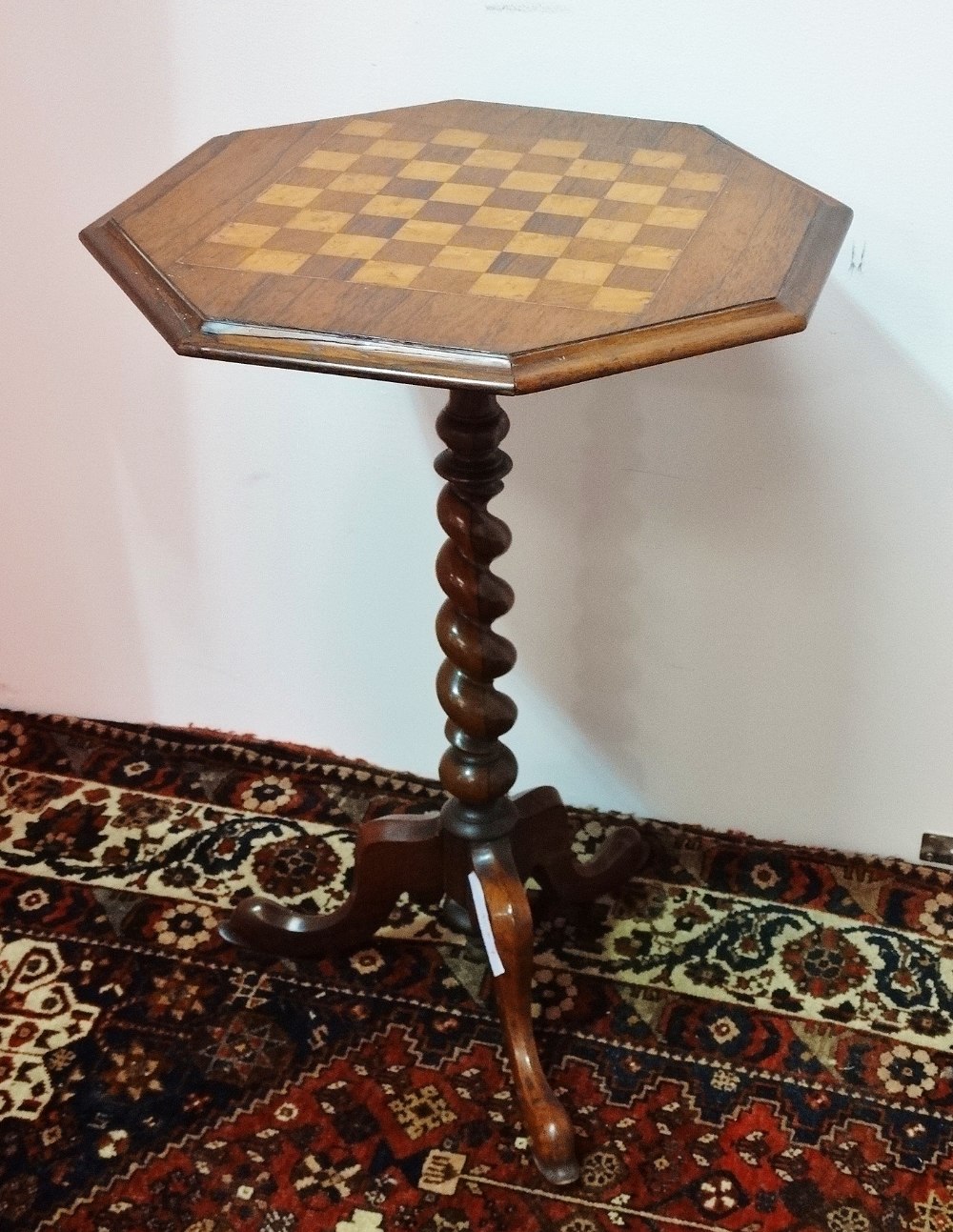 A late 19th century rosewood games table, the top with inlaid satin birch chessboard raised on