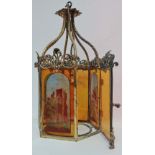 A Victorian style brass framed hall lantern, fitted amber glass panels, three painted with rural