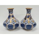 Losol Ware, a pair of blue and white gilt decorated faceted baluster vases, height 23cm.