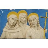 A large 20th century Italian pottery plaque, relief decorated with three saints, painted '892 ITALY'