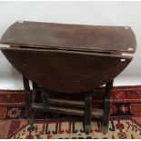 An early 18th century oak oval drop leaf gateleg table of small proportions, fitted a long drawer