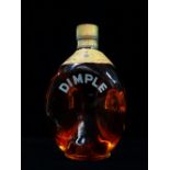 A bottle of Dimple Scotch whisky 26 2/3 flozs, 70% proof.