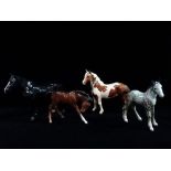 Four Beswick horse figurines, including 'Dale' and a dappled pony, largest height 17cm.