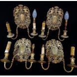 A set of four 17th century style twin branch wall lights, the back plates cast with cherubs