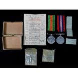 A WWII Defence medal and War medal with ribbons in original postage box.