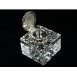 A George V silver hinge lidded cut glass large cube inkwell with hobnail cut base, indistinct