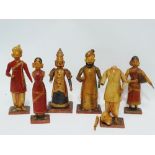 A group of six early 20th century Indian carved, gilt and polychrome painted figures, height of