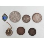 A small collection of international coins, including Chinese.