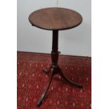 A George III mahogany snap top tripod wine table, with turned barrel suppport, height 77cm, diameter