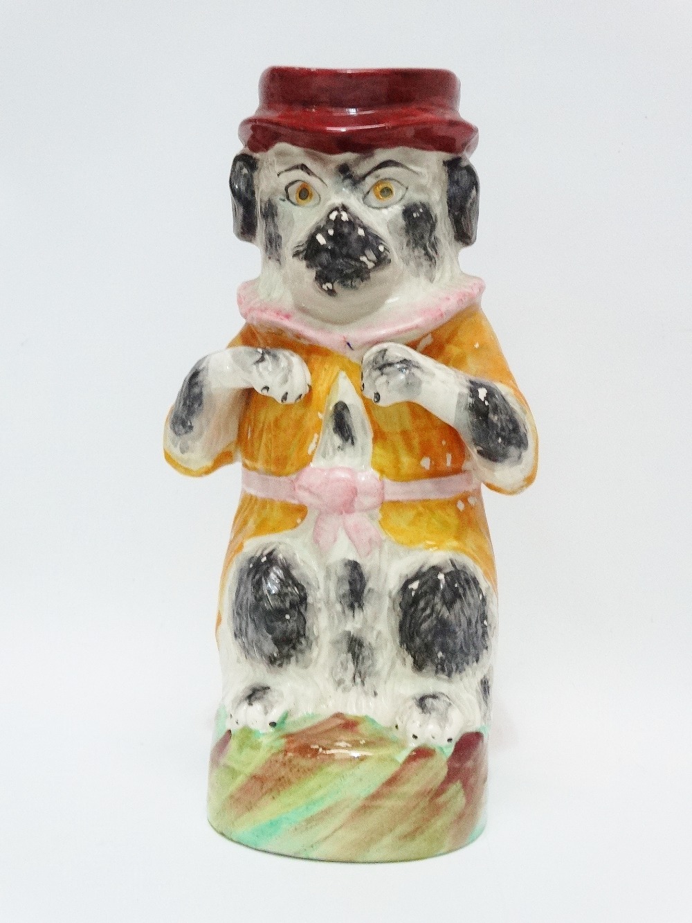 A 19th century Staffordshire Pottery jug in the form of a dog wearing a ruff, coat and hat, height