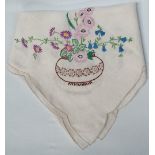 An early 20th century tablecloth embroidered with spring flowers, 110 x 110cm.