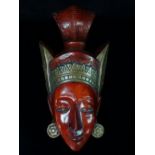 A European pottery wall mask in the manner of Goldscheider, modelled as a Balinese female mask,