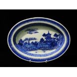 A 19th century Chinese export porcelain blue and white oval dish decorated with a pagoda and figures